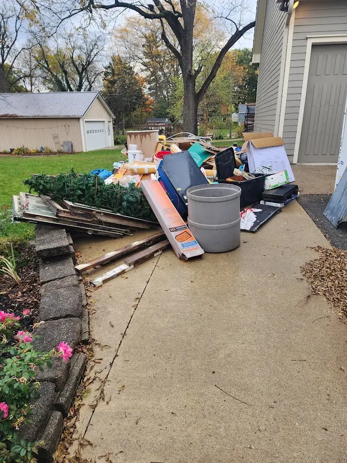 Dumpster being loaded with debris for Estate Cleanout Dumpster Rental in Maysville